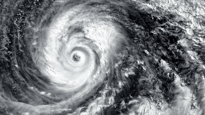 Satellite image of a hurricane’s eye and swirling cloud bands during peak hurricane season.