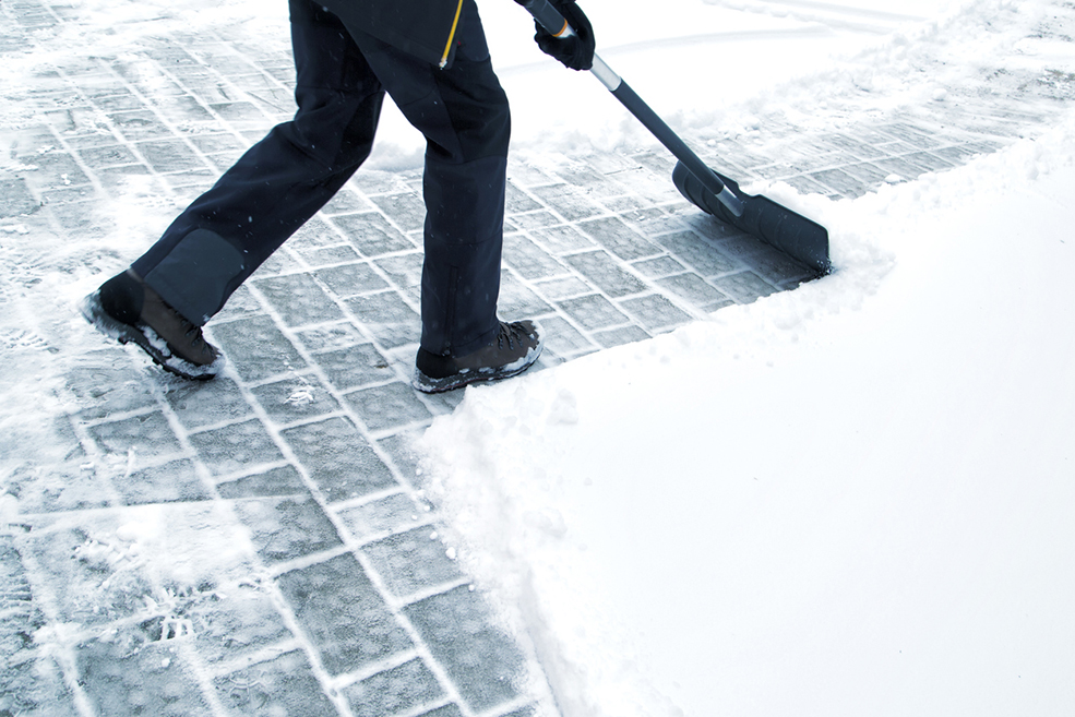 Man with shovel cleaning snow